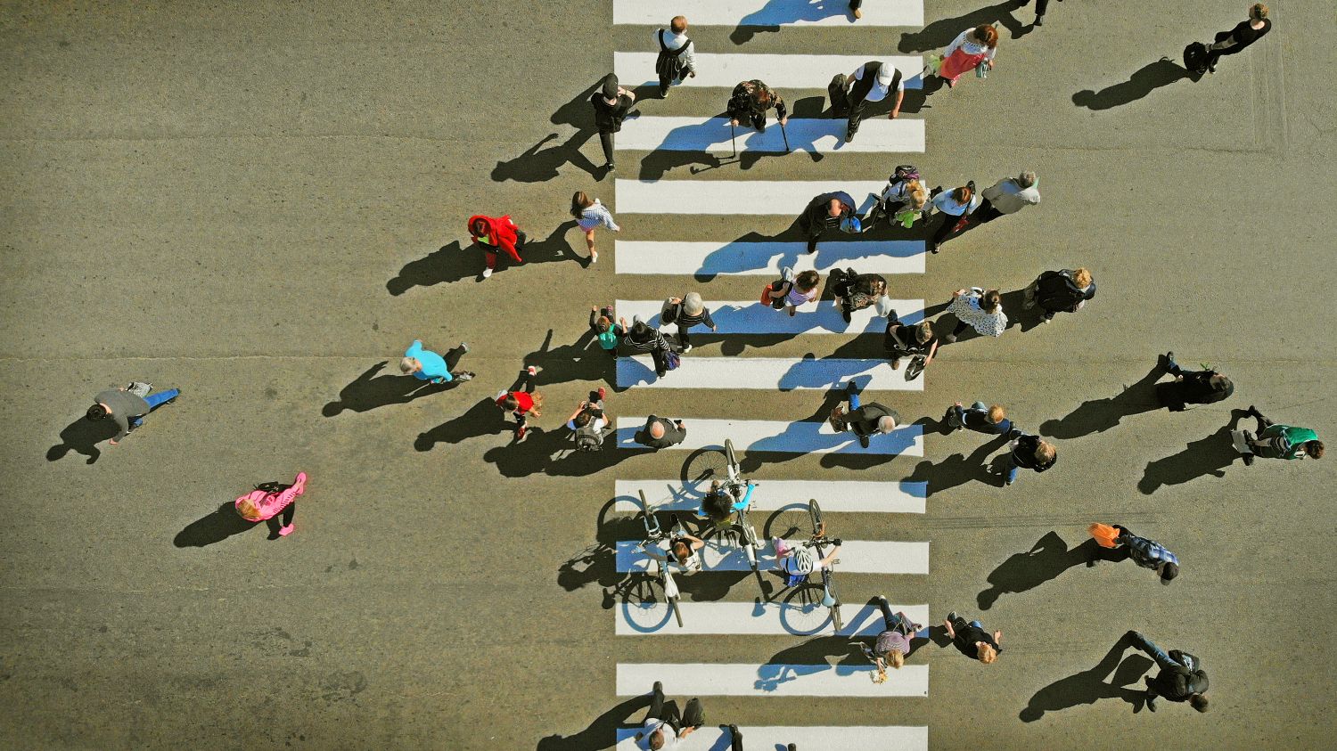 Fußgänger und Radfahrer auf einer Straße in der Vogelperspektive